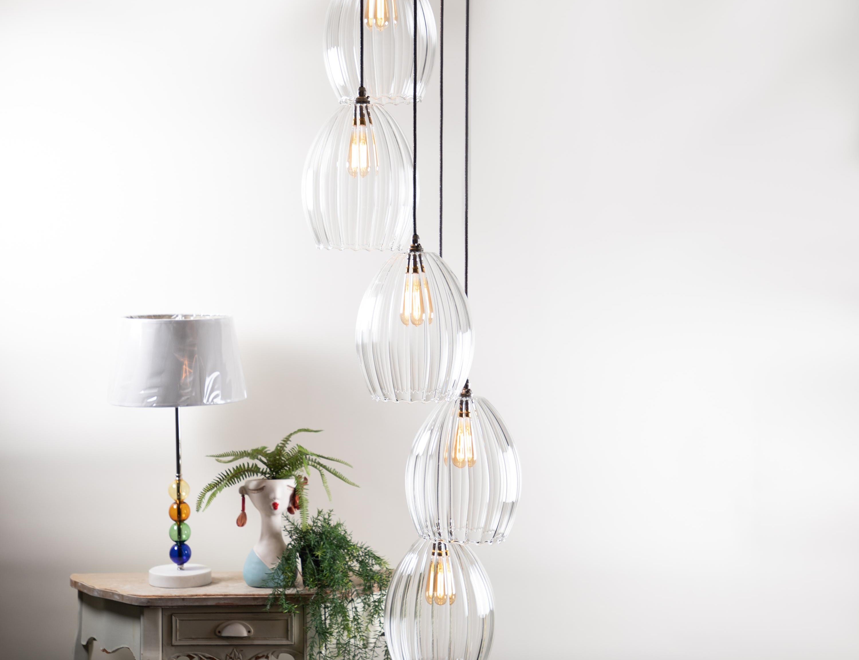 5 Way Large Glass Cluster Light illuminated next to a side table