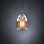 Medium ribbed glass pendant light featuring an illuminated bulb and black cable.