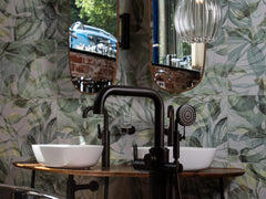 Modern bathroom featuring copper roll top bath tub and large ribbed glass pendant light