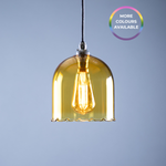 Yellow pendant light with a visible bulb against a grey background