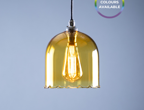 Yellow pendant light with a visible bulb against a grey background