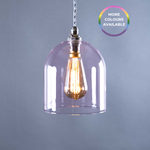 Pink glass pendant light with a visible bulb on a grey background