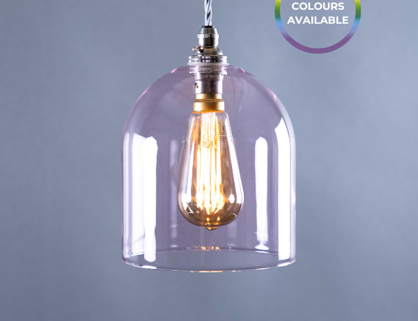 Pink glass pendant light with a visible bulb on a grey background