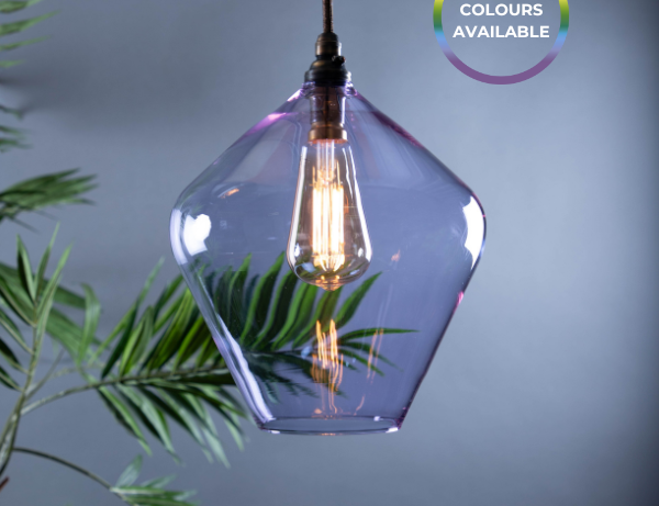 Decorative coloured pendant light with a geometric glass shade and visible antique style bulb, against a dark neutral background.