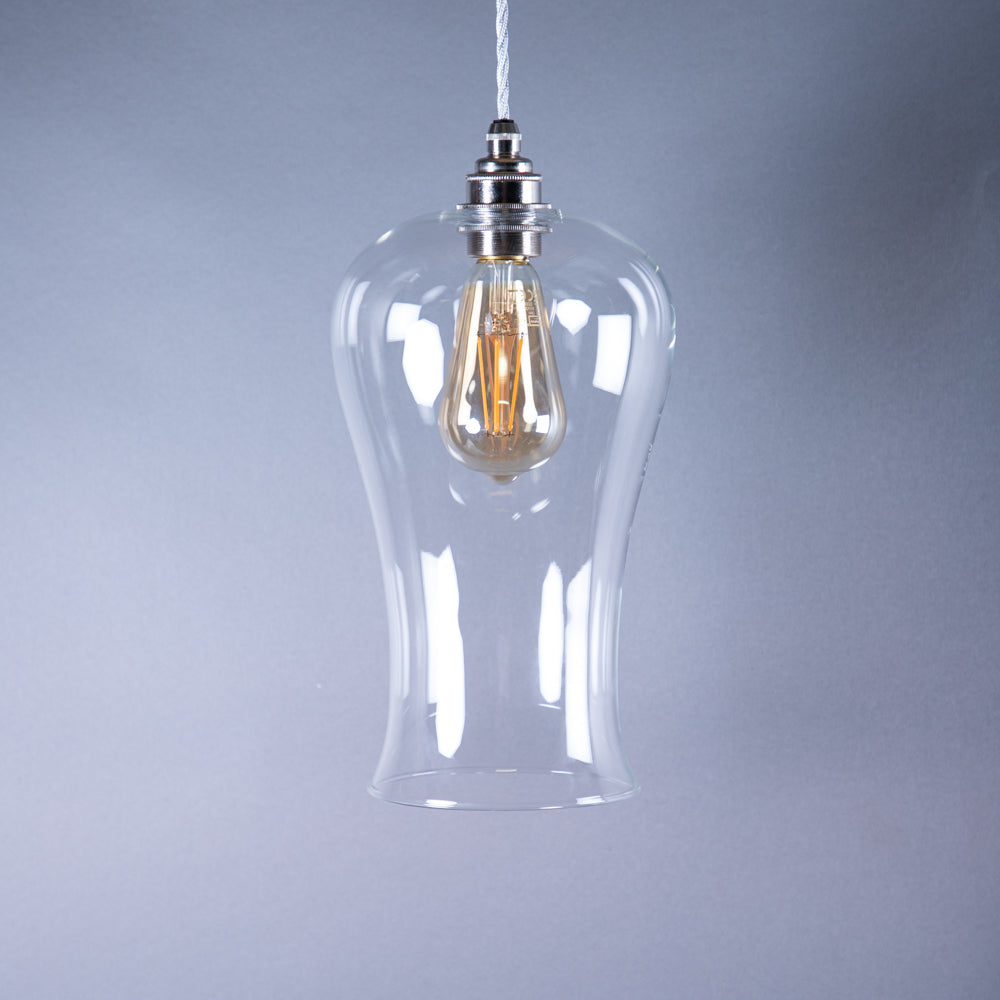 Large hourglass shaped glass pendant light with illuminated antique style bulb