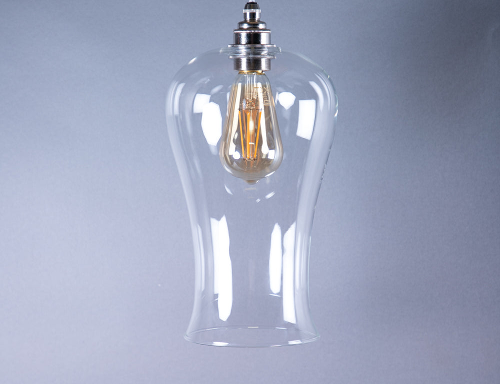 Large hourglass shaped glass pendant light with illuminated antique style bulb