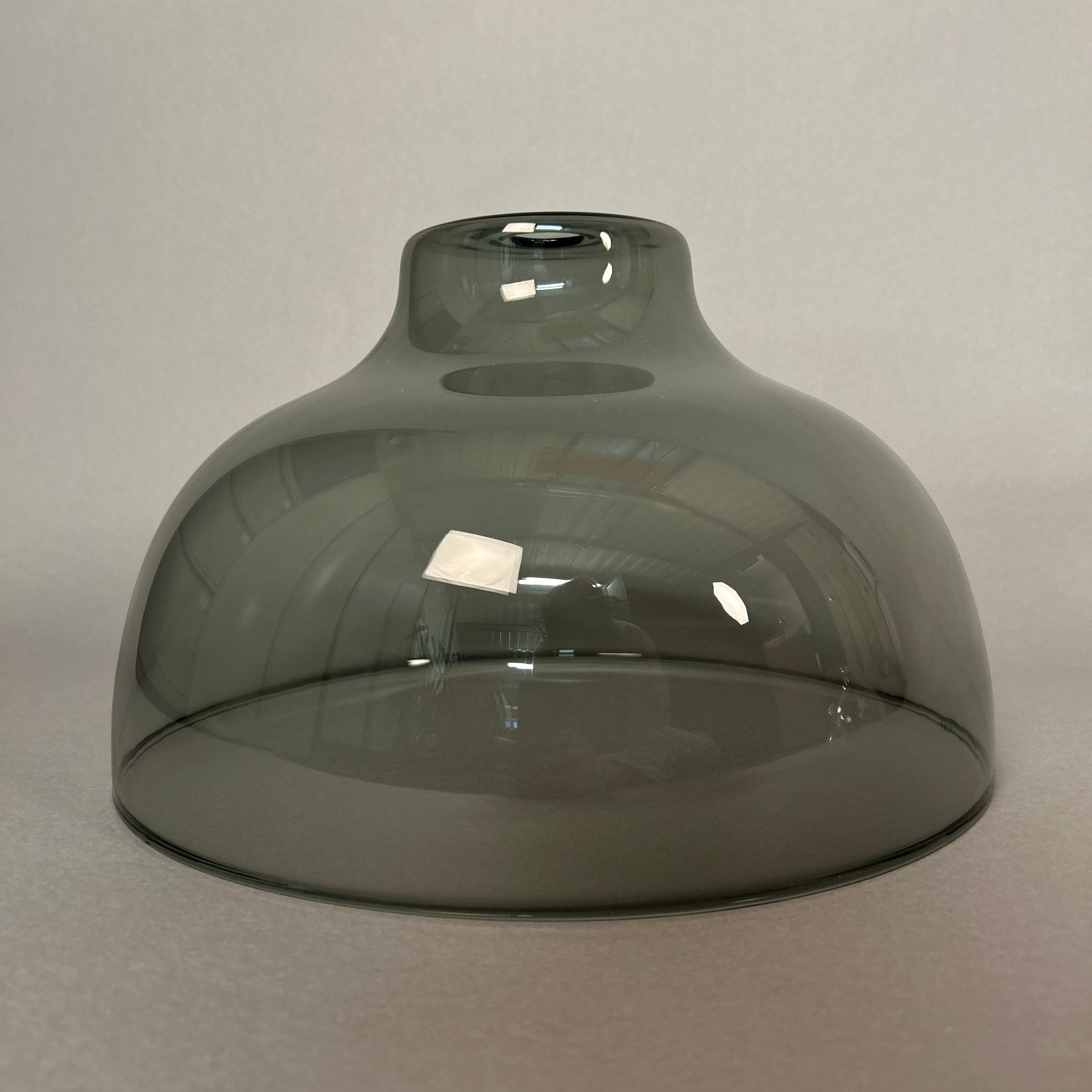 Dark grey dome-shaped light on a light grey background