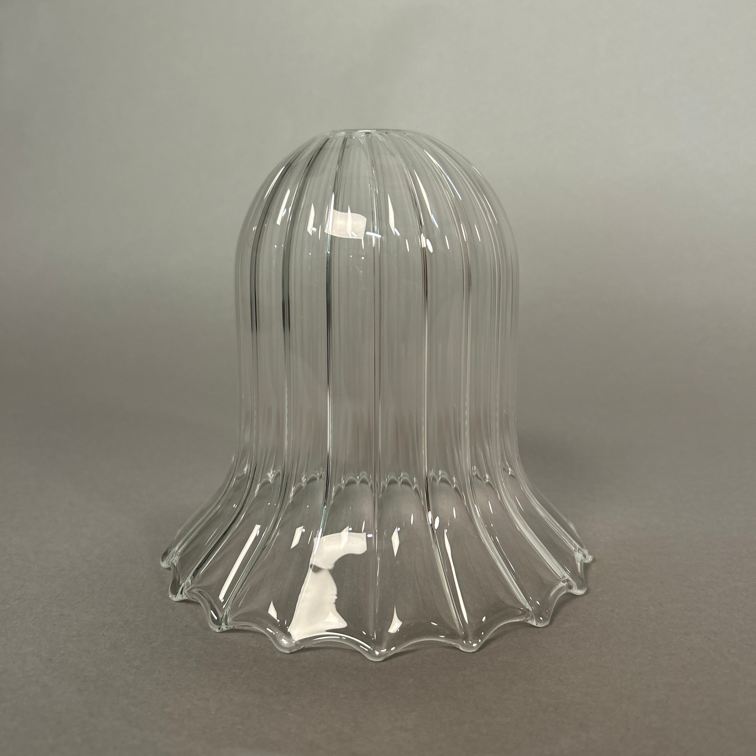 Clear glass light with ribbed design on a grey background