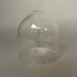 Clear glass pendant light on a light grey background