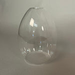 Clear glass pendant light on a light grey background