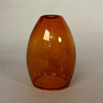 Amber glass light on a plain white background