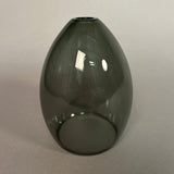 Dark grey glass pendant light on a light grey background