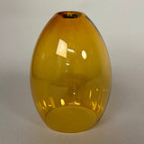 Yellow ceiling glass pendant light fixture on a white wall