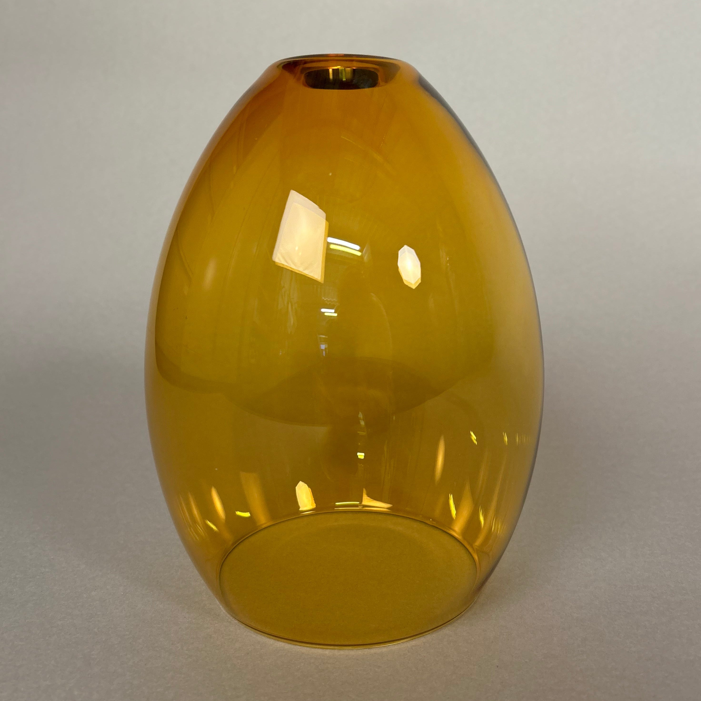 Yellow ceiling glass pendant light fixture on a white wall