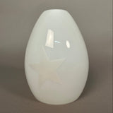 White glass pendant ceiling light fixture on a grey wall