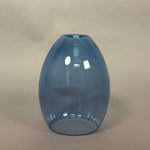 Blue glass vase on a beige background
