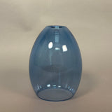 Blue glass vase on a beige background