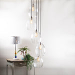 5 Way Large Glass Cluster Light illuminated next to a side table